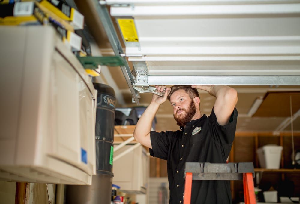 Garage door repair man fixing a garage door