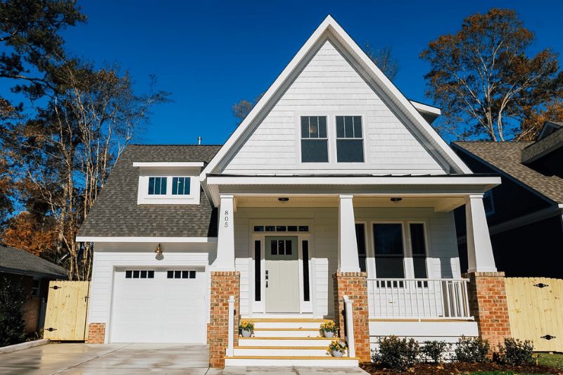 Stamped Carriage House garage door in White with Madison window inserts